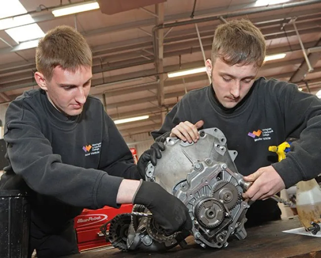 Motor Vehicle students working on engine in workshop