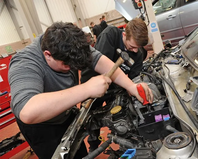 Motor Vehicle students working on car together in workshop