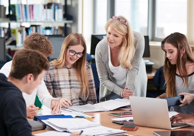 Teacher working with students (Education & Training thumbnail image)