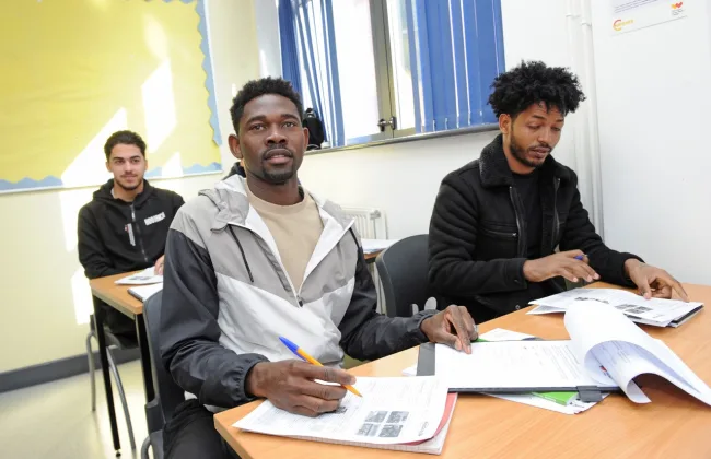 Male ESOL students sitting in classroom (ESOL thumbnail image)