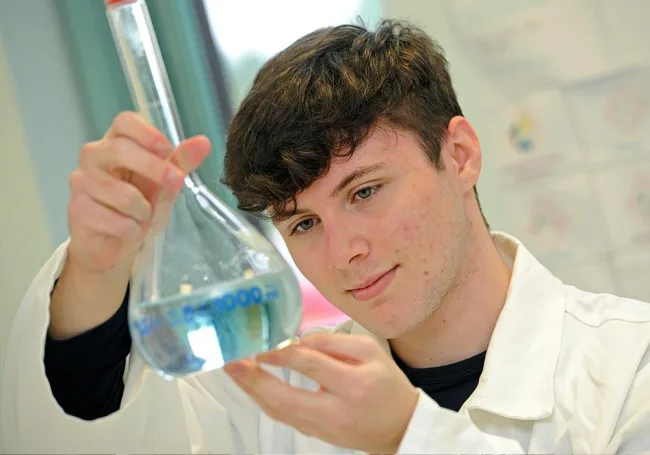 Science student holding beaker